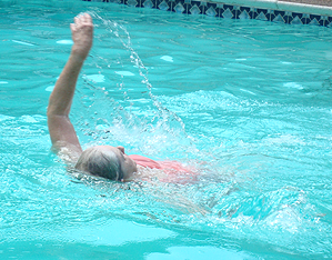 image of Knight swimming the backstroke