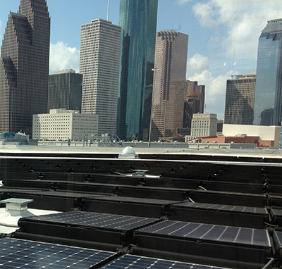 solar panels on roof with view of Houston skyline