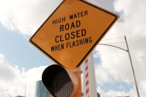 high water road closed when flashing street sign