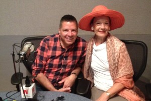 Photo of Kenn McLaughlin and Sally Edmundson smiling for the camera in the radio studio