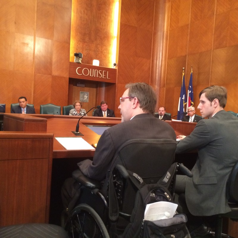 Toby Cole (left) addresses a city council committee