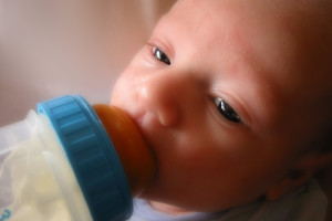 photo of a baby drinking bottle