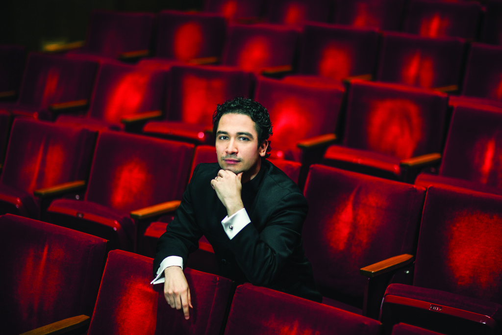 Conductor Andrés Orozco-Estrada sitting in the seats in Jones Hall looking at the camera