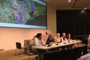 Panelists sit at a table discussing conservation in Houston.