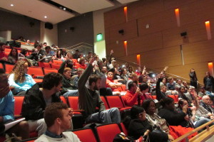 Students and others raise their hands if they have a concealed handgun license at a forum on the new campus carry law. It takes effect next August and will allow licensed holders to carry handguns on public Texas colleges.