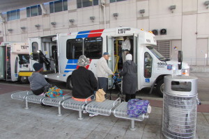 MetroLift customers board paratransit buses outside Metro's downtown headquarters.