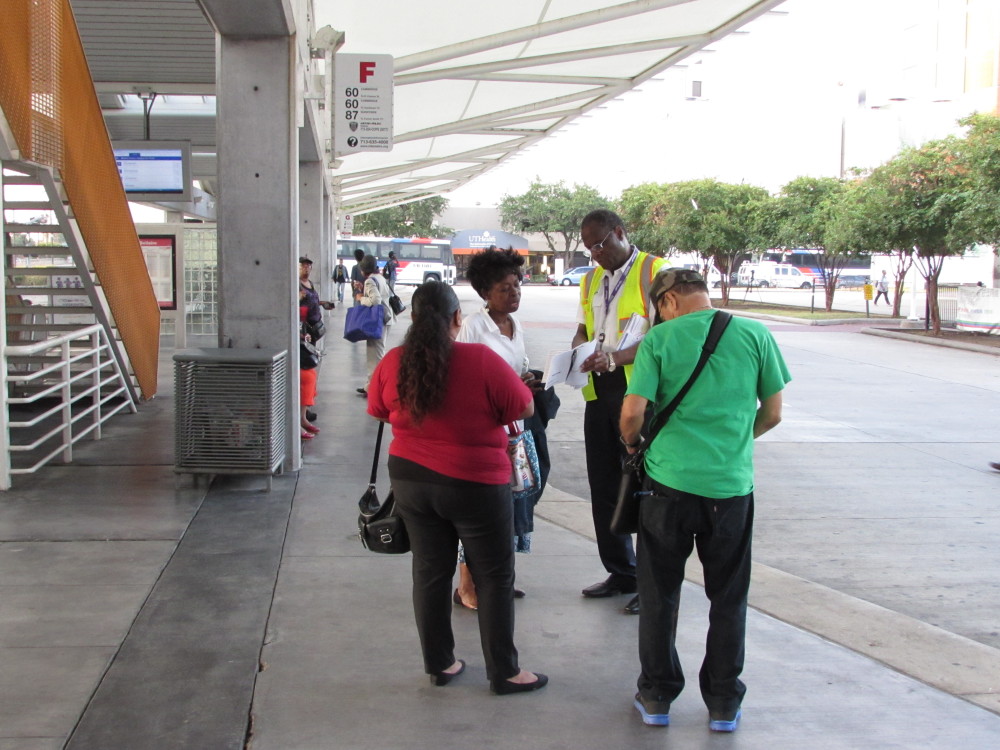 A Metro representative assists riders at the Texas Medical Center transit hub. 