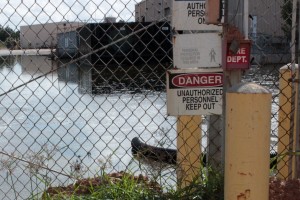 danger sign in front of a water source