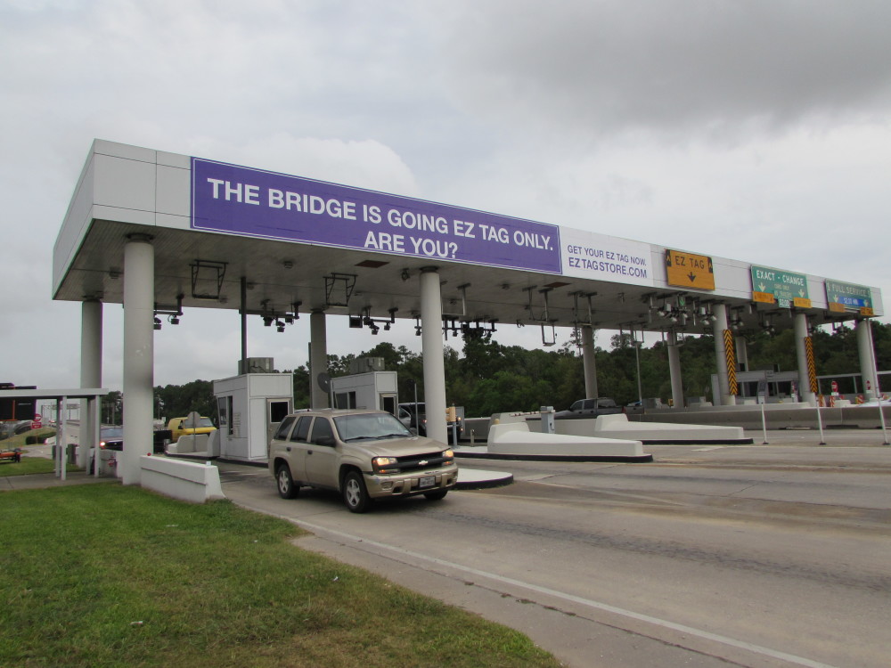 Signs at HCTRA's Ship Channel Bridge advise drivers of change to all-electronic tolling.  