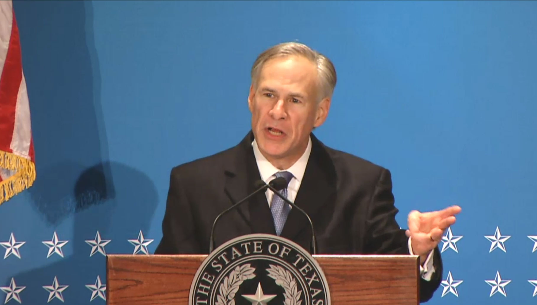 Governor Greg Abbott speaking at the podium