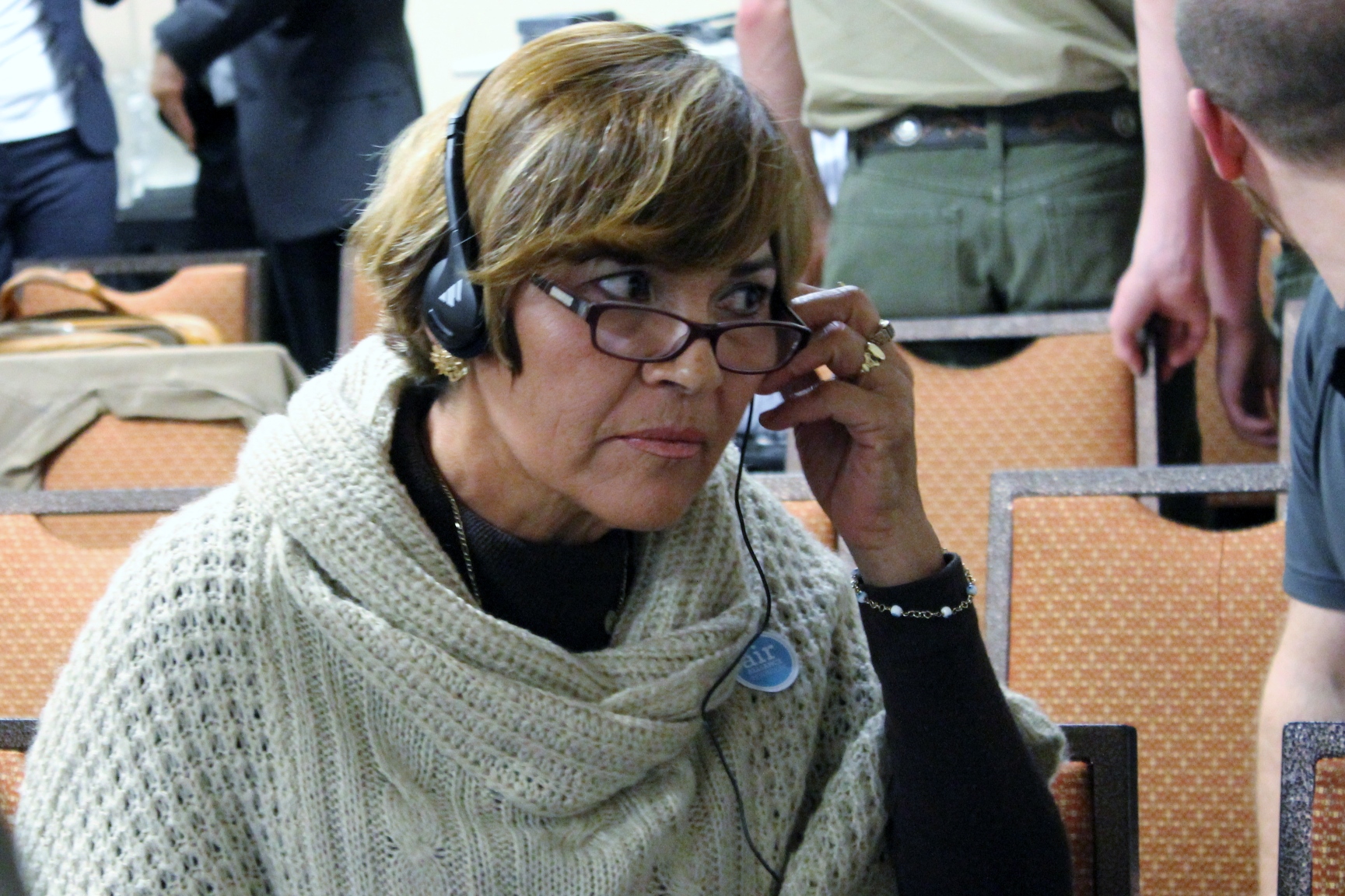 Araceli Ochoa listens to interpreter translating the hearing into Spanish