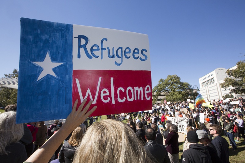 sign held up in support of refugees in Texas