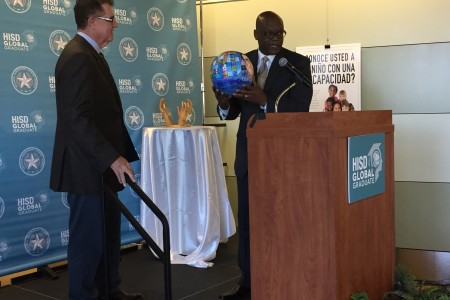 HISD Superintendent Terry Grier receives a parting gift, some artwork by students, from HISD's community liaison Lawrence Allen at a goodbye celebration last week.
