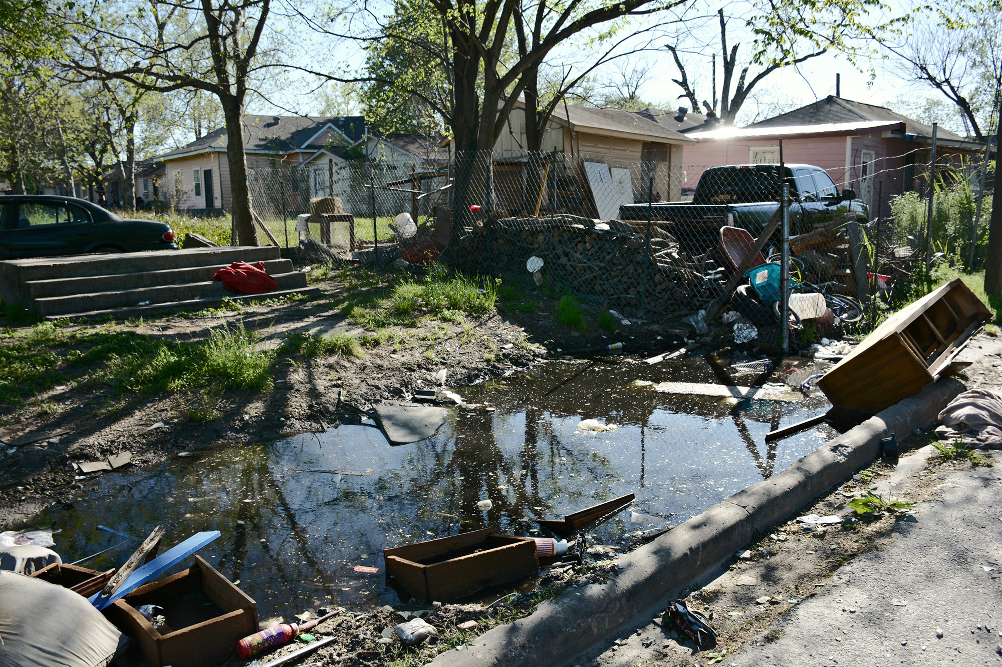 Standing water and abandoned tires make Houston's Fifth Ward hospitable for mosquitoes.