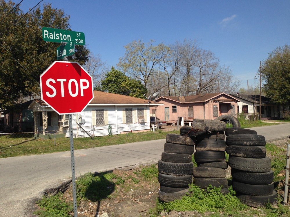 tires dumped by a stop sign 
