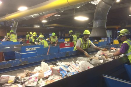 Workers separate materials for recycling.