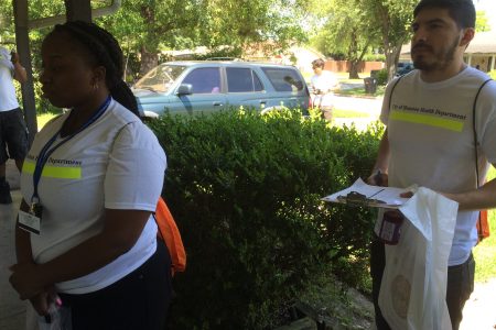 Kalicia Minor and Daniel Perez with the Houston Health Department knock on a door in a northwest Houston neighborhood.
