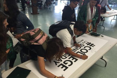 Seniors at Austin High School participate in a college signing day to celebrate their next steps after high school.