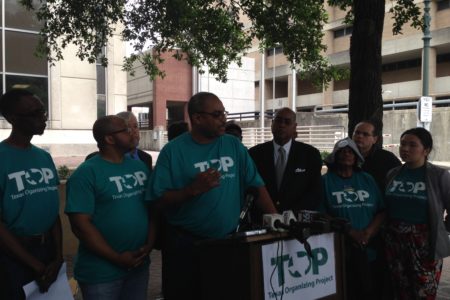 Texas Organizing Project member Feldon Bonner (center) speaks at a press conference held in front of the Harris County Criminal Court building. The activist organization advocates for changes in the county’s bail system.