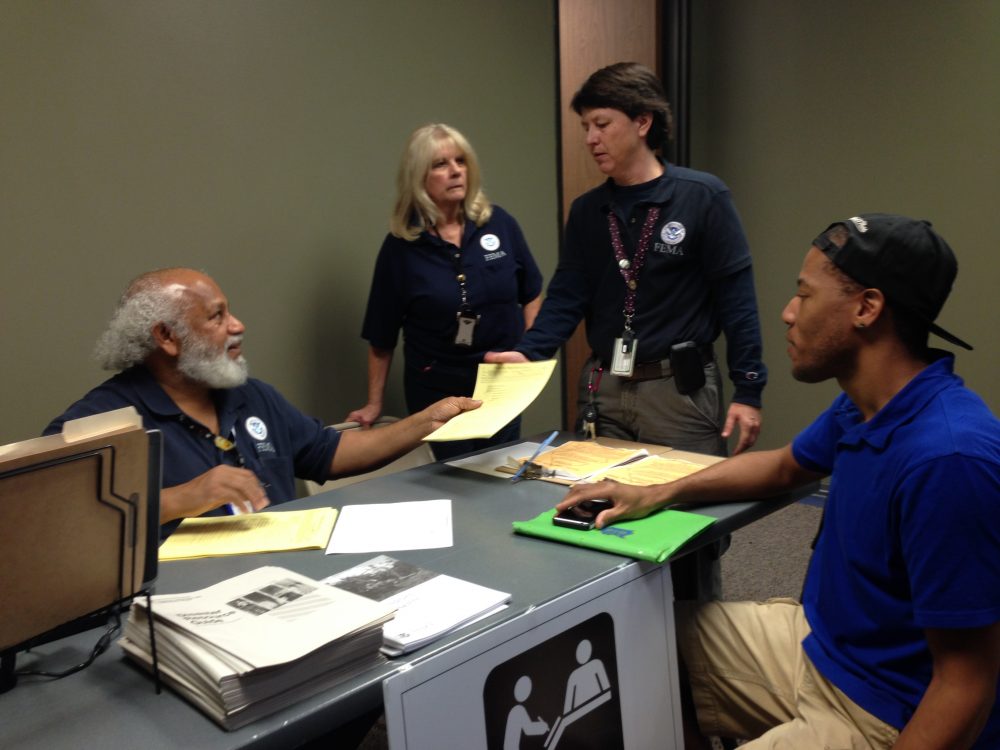Dante Jones receives assistance from FEMA representative Paul McFarlane at the disaster recovery center the agency has opened in the Greenspoint area.