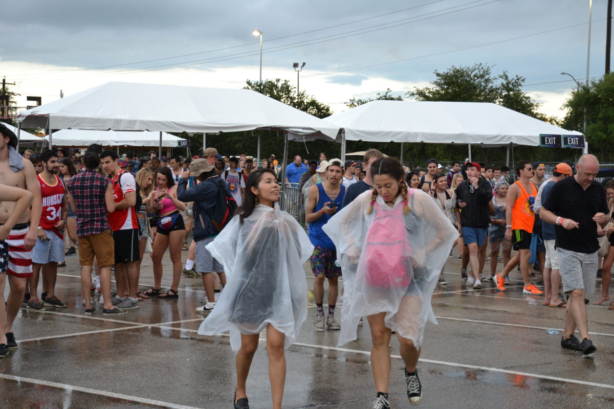 Concert goers brave the rain during the 2016 Free Press Summer Fest, held at the NRG Stadium parking lot for the second year in a row because of severe weather. (Photo: Amy Bishop, Houston Public Media)