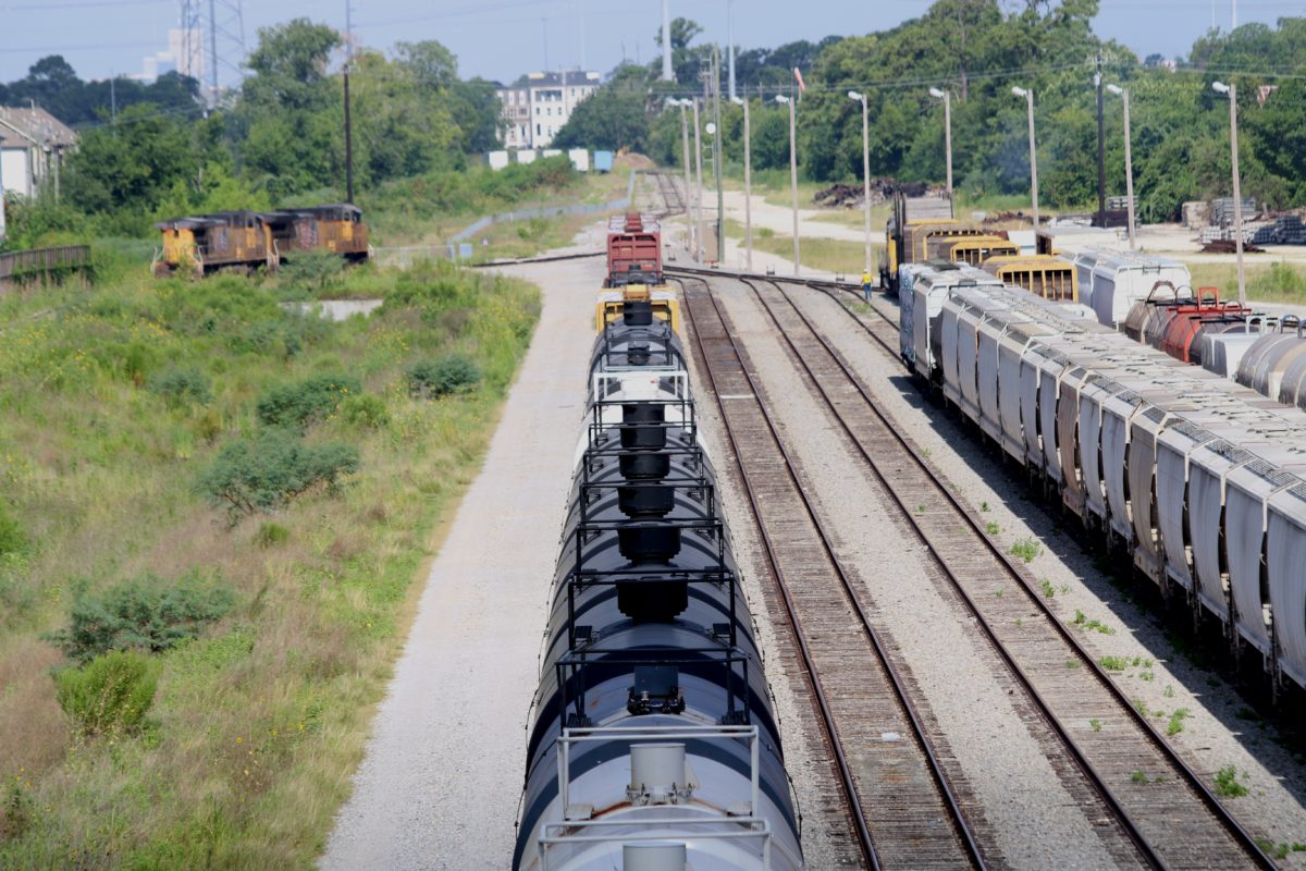 Tank cars for carrying crude oil (the ones painted black) sit on tracks near homes west of downtown Houston. (Photo: Dave Fehling, Houston Public Media)