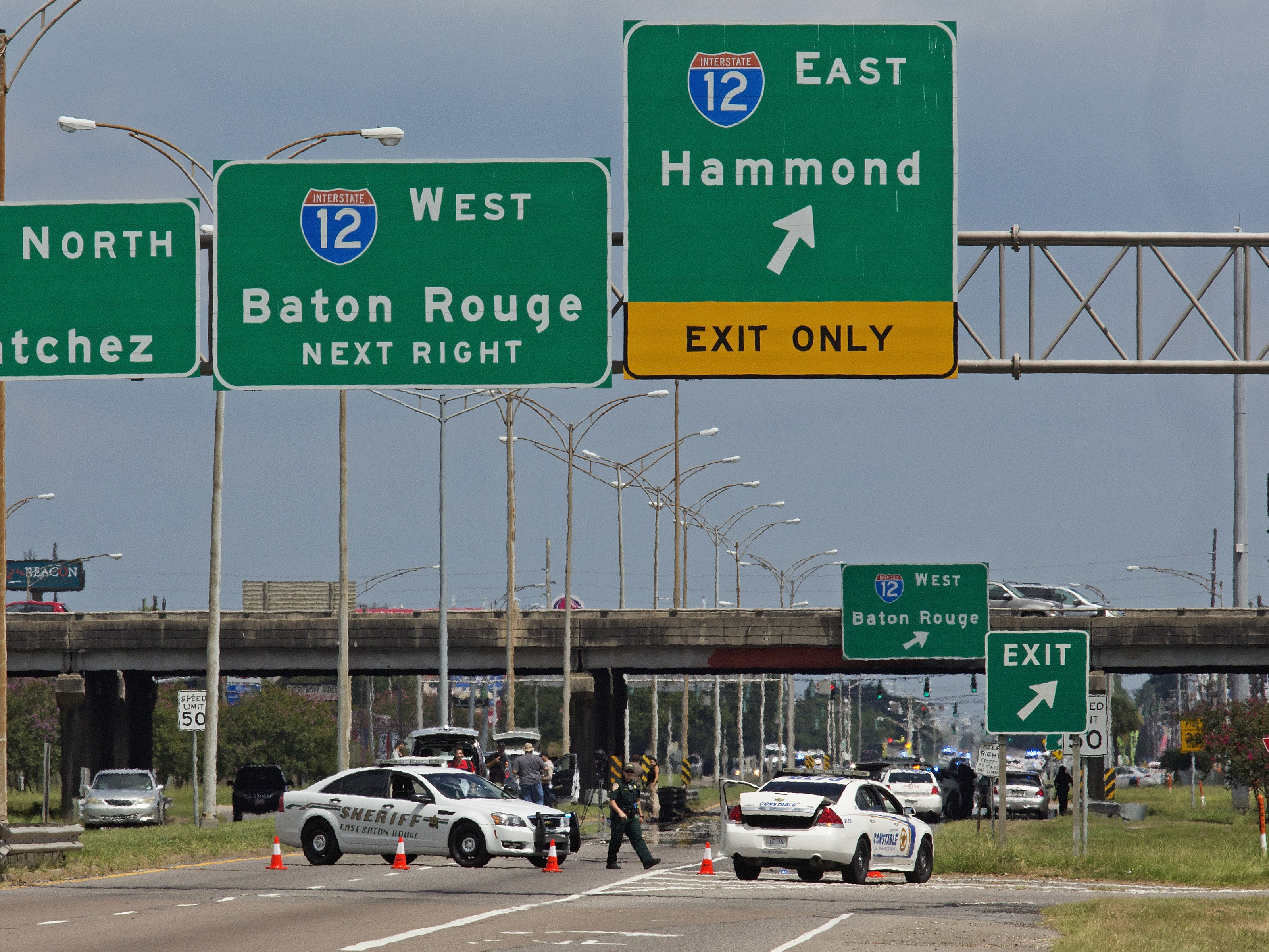 Baton Rouge police block Airline Highway after police were shot in Baton Rouge, La., Sunday, July 17, 2016. Authorities in Louisiana say several law enforcement officers are dead, and several injured in Baton Rouge after on-duty law enforcement officers were shot on Sunday morning.
