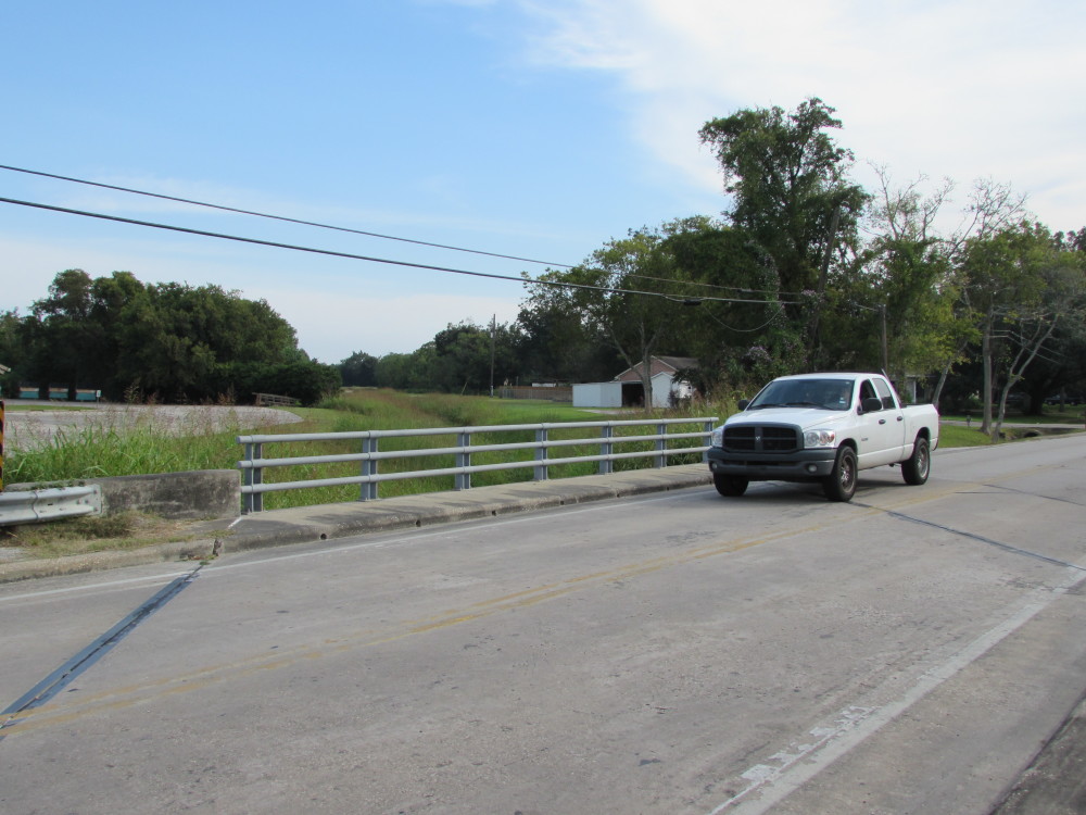 A truck passes over a bridge built by Harris County on Runneburg Road in Crosby. (Photo: Gail Delaughter, Houston Public Media)