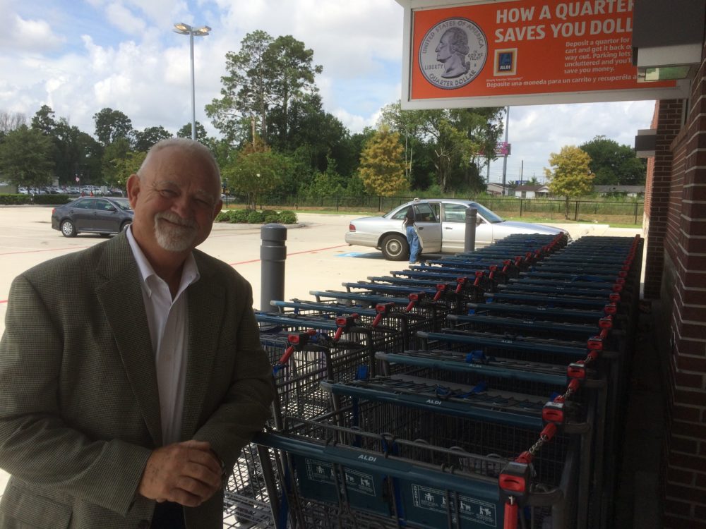 Joe Williams with the Texas Retailers Association stands in front of an Aldi. The grocery store chain requires a 25 cent deposit for its shopping carts.