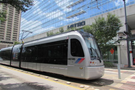Light rail train in front of Metro's headquarters on Main Street. Officials say they're hearing support for extending rail service to Hobby Airport.