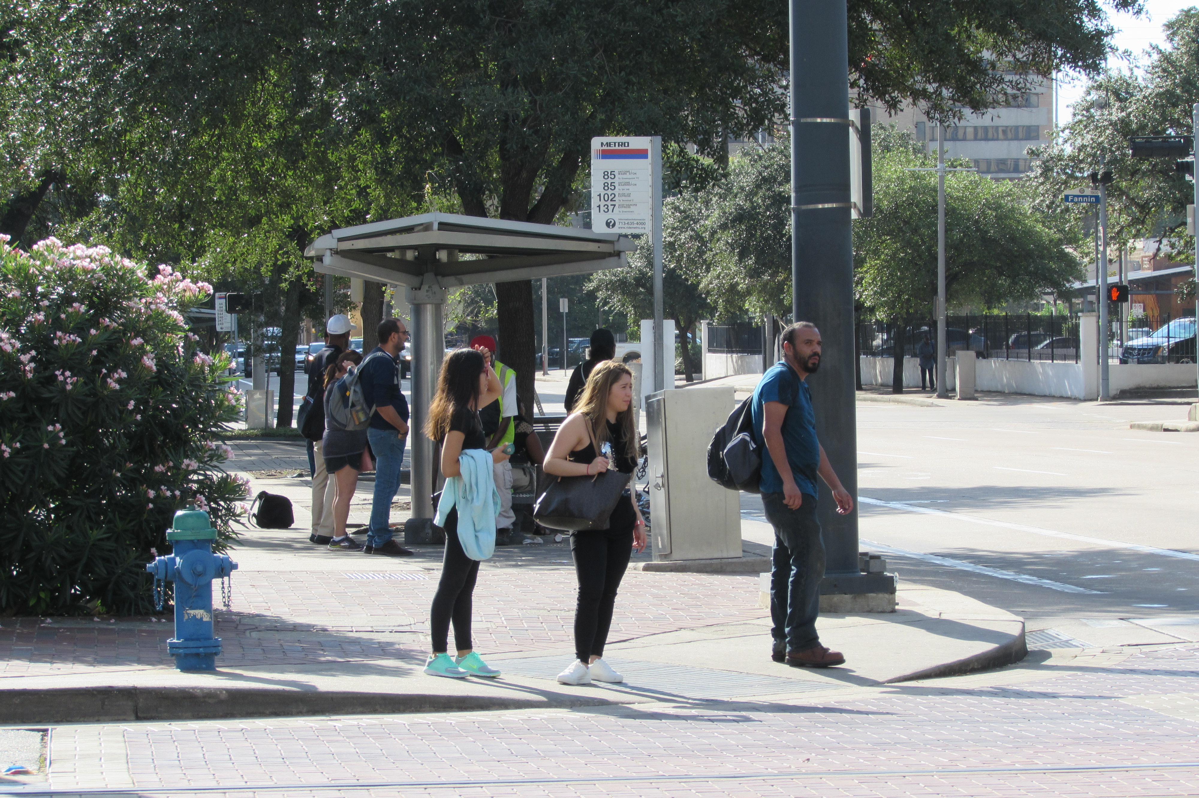 Riders wait for the bus near Metro's downtown headquarters. 