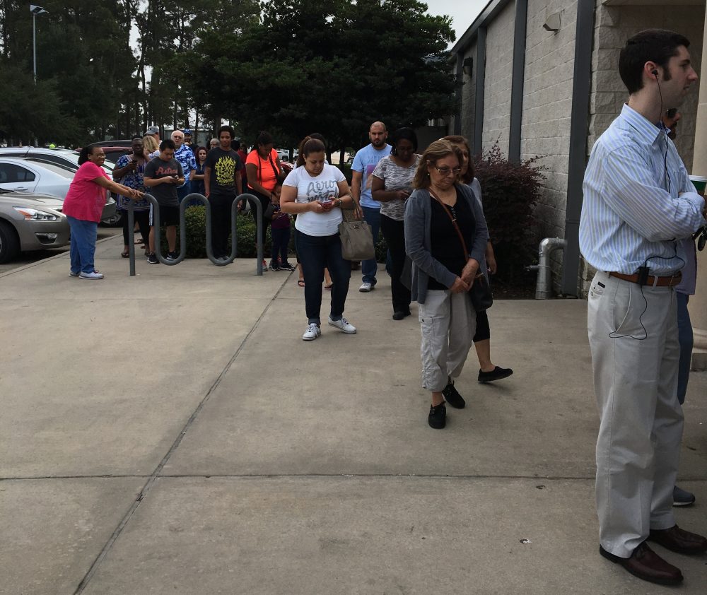 Voters stand in line to cast a ballot at an early voting location in Humble on November 4.
