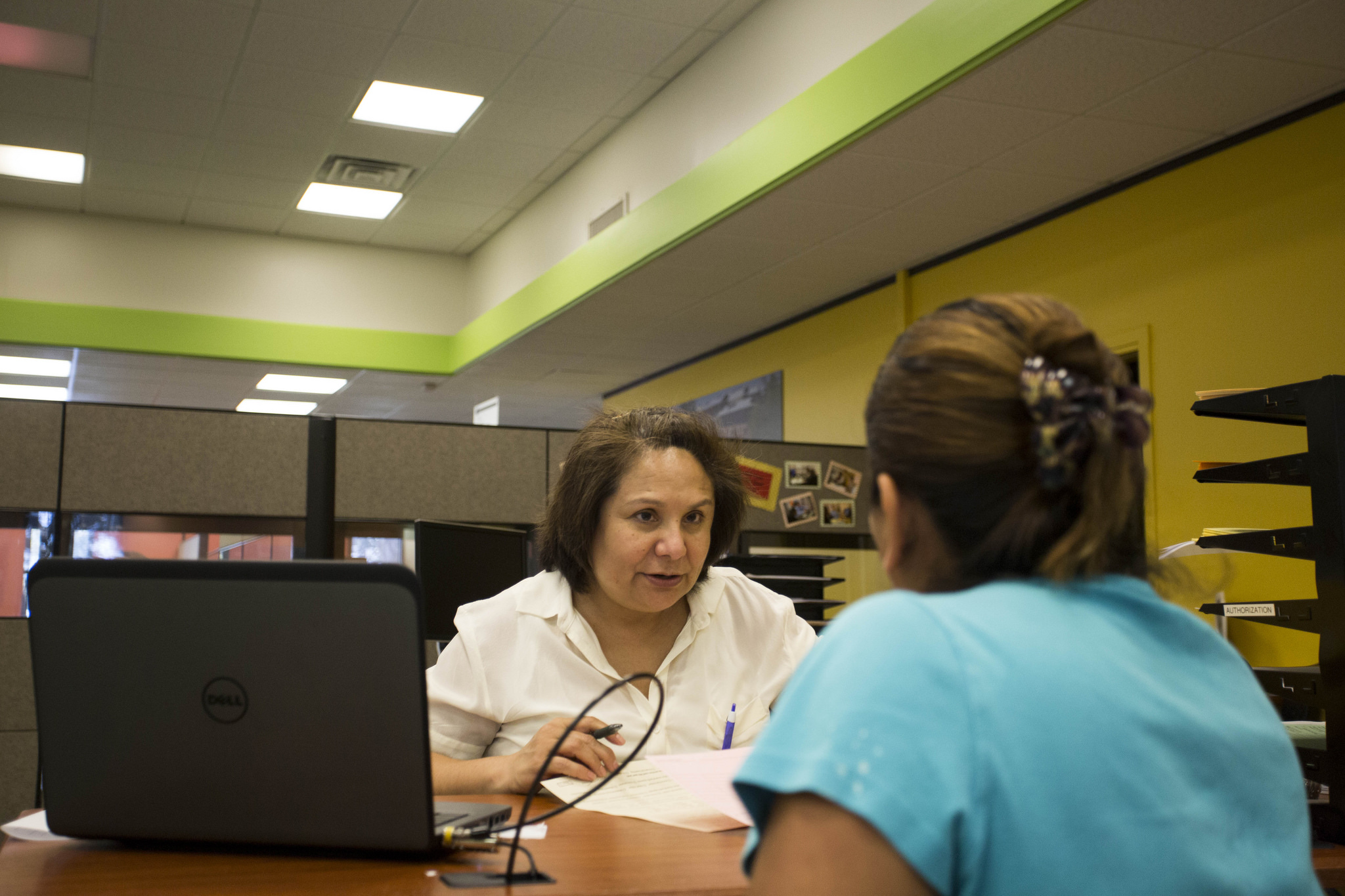 Nora Cadena, of Insure Central Texas at Foundation Communities, assists with enrollment in the Affordable Care Act at a Foundation Communities Community Tax Center in North Austin.