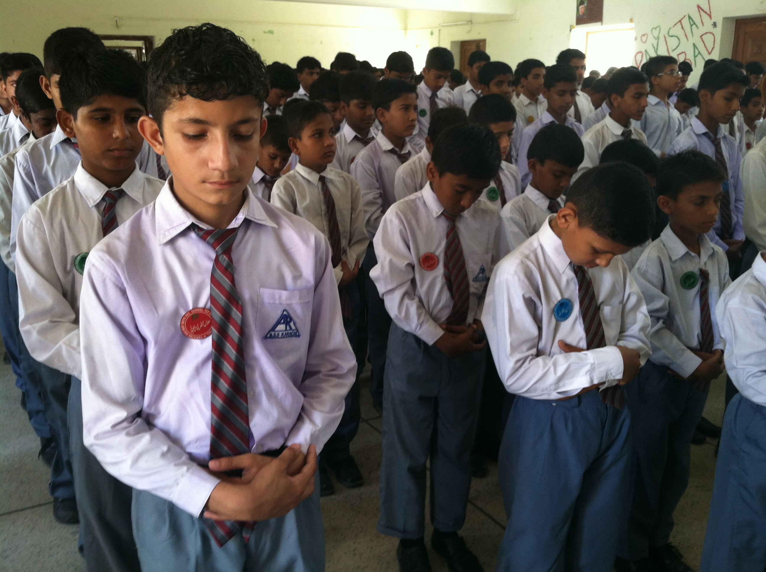 Middle and high school boys line up for the opening assembly with prayer and the pledge of allegiance at the Pakistani Railway School in Karachi, The school was adopted by the nonprofit, The Citizens Foundation, last year and has already seen a jump in test scores.