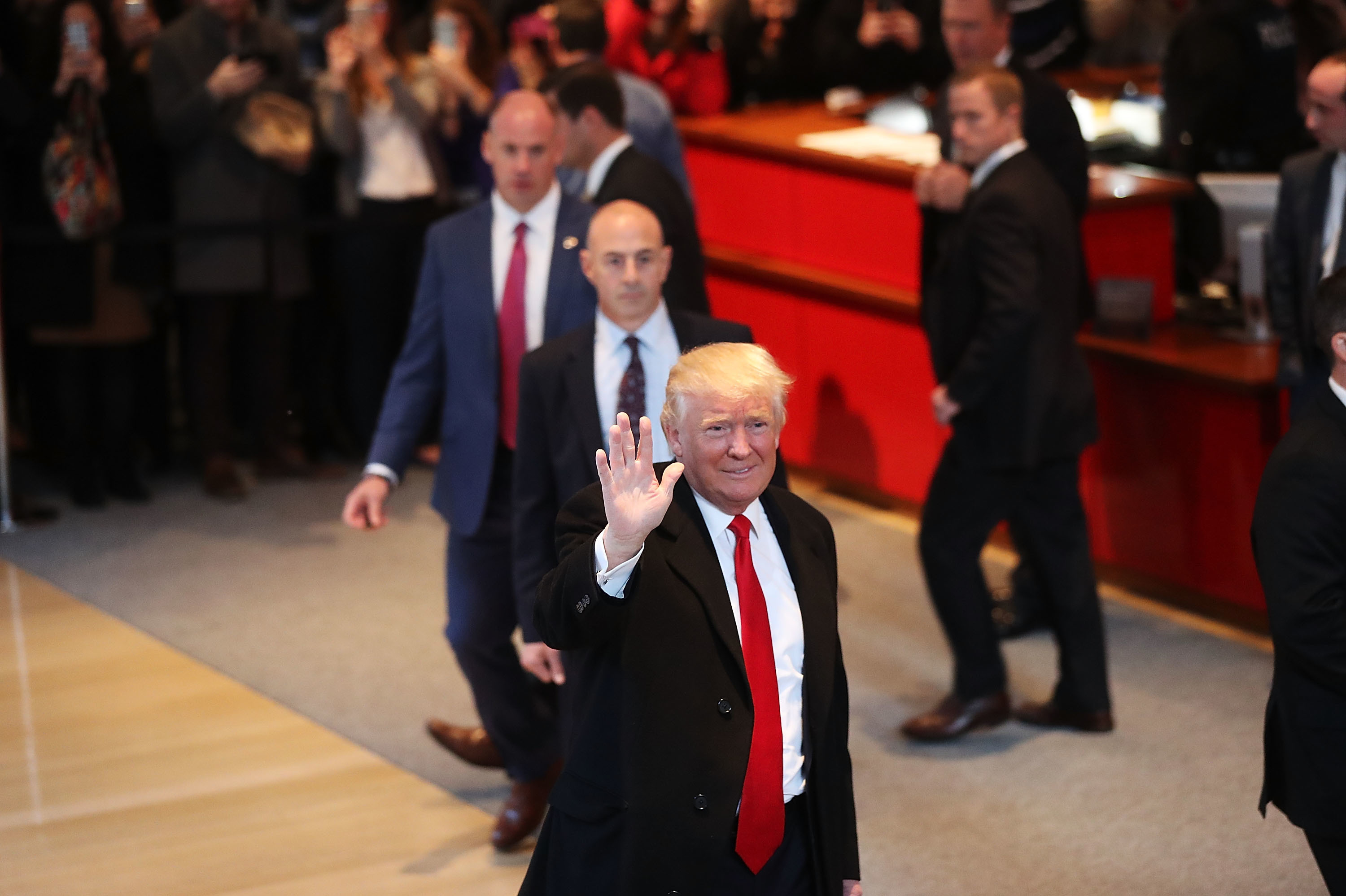 President-elect Donald Trump walks through the lobby of the New York Times following a meeting with editors at the paper on Tuesday in New York City