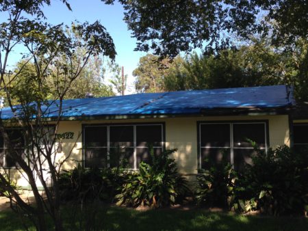 Tarps such as the one this photo shows covered the roof of Ms. Huff’s home for eight years.