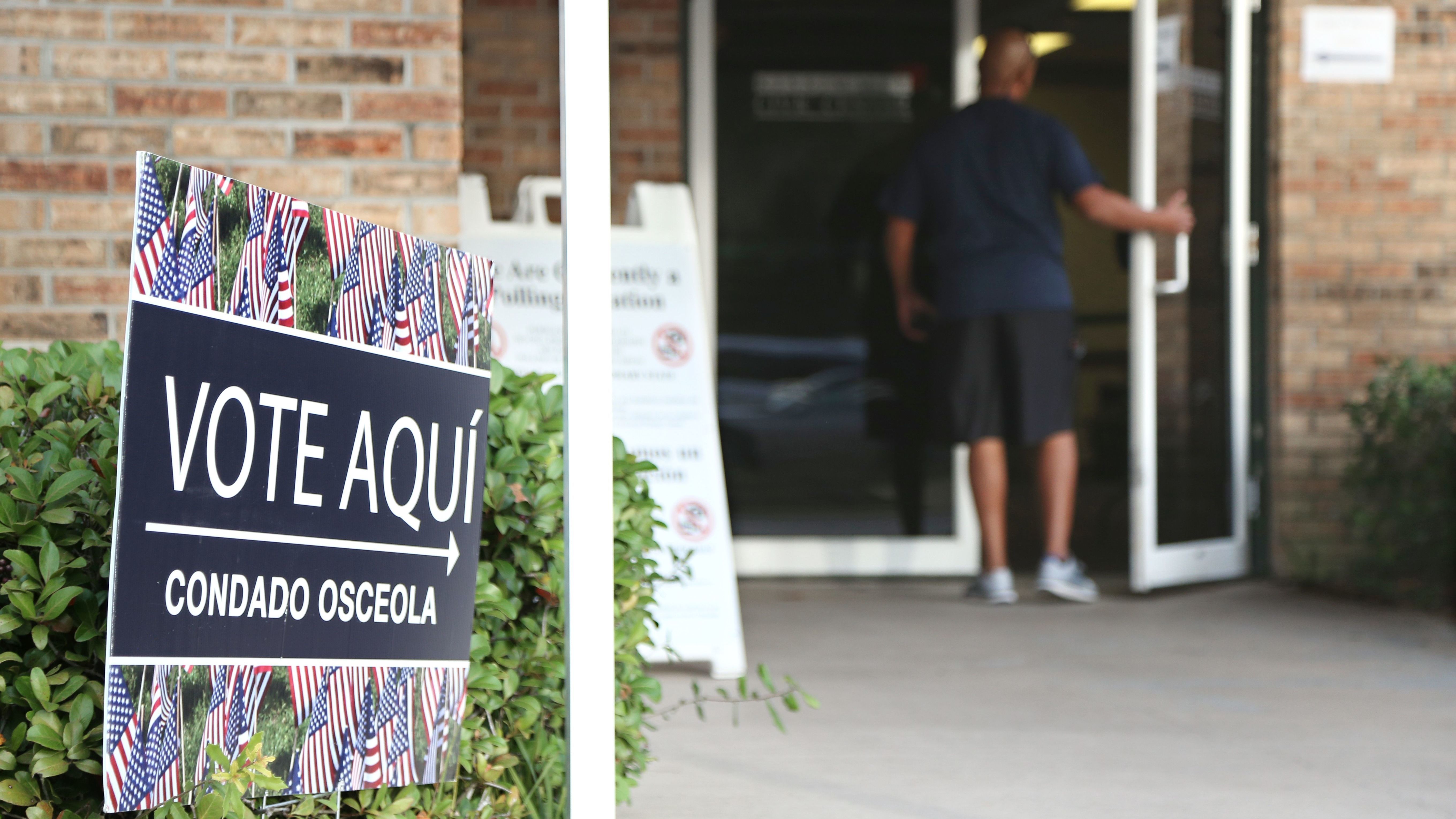 A voter enters an Osceola County polling station during early voting in the federal election in Kissimee, Florida on October 25, 2016.
