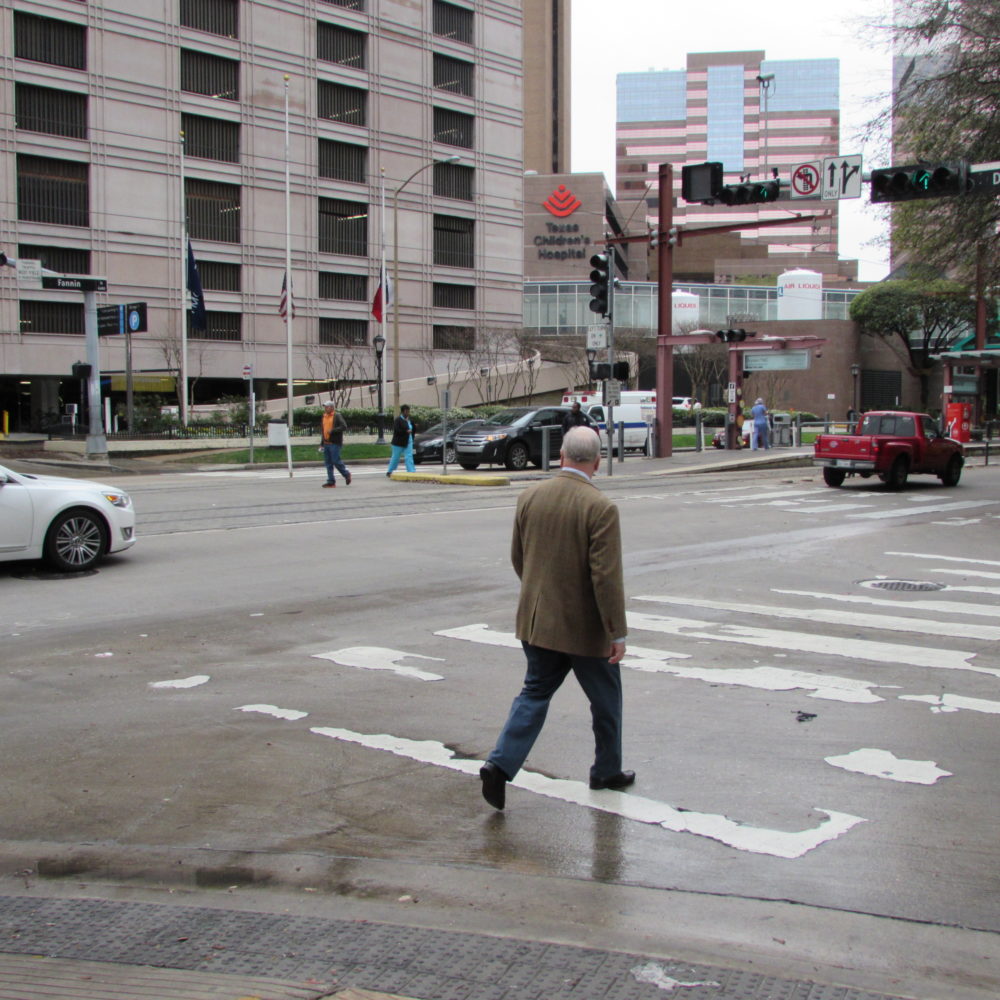 Pedestrians cross the street in the Texas Medical Center