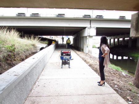 Westchase District Vice-President of Projects Irma Sanchez checks out the lighting installation along the Brays Bayou Connector Trail.