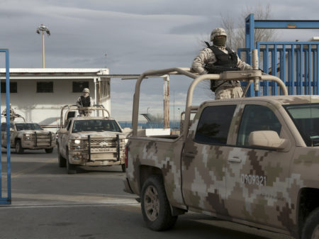 Mexican soldiers leave the airport in Ciudad Juarez, Mexico, after authorities handed over drug lord Joaquin "El Chapo" Guzman to U.S. officials.
