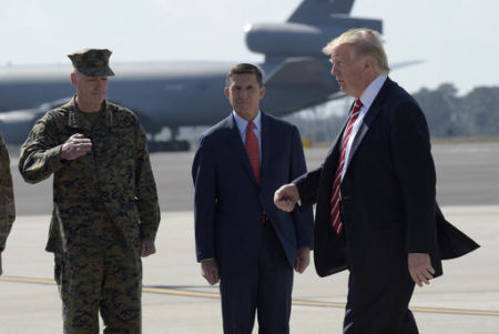 President Donald Trump passes  Joint Chiefs Chairman Gen. Joseph Dunford, left, and National Security Adviser Michael Flynn as he arrives via Air Force One at MacDill Air Force Base in Tampa, Fla., Monday, Feb. 6, 2017. Trump stopped for a visit to the headquarters for U.S. Central Command and U.S. Special Operations Command before returning to Washington.
