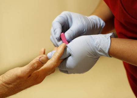 FILE - In this Wednesday, May 1, 2013, file photo, a lab technician draws blood from a patient at a health center, in Phoenix.