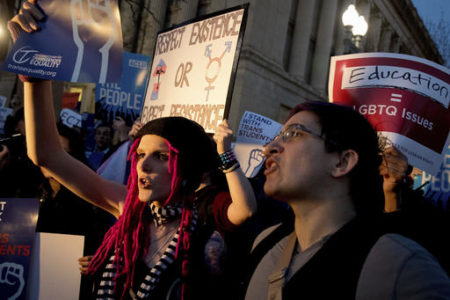 Activists and protesters with the National Center for Transgender Equality rally in front of the White House, Wednesday, Feb. 22, 2017, in Washington, after the Department of Education and the Justice Department announce plans to overturn the school guidance on protecting transgender students.