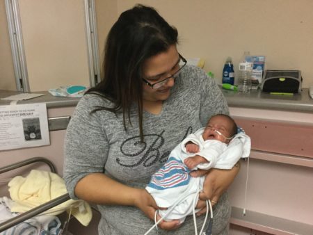 Connie De La Rosa holds baby Angel in the NICU at University Hospital. She's the first participant in a new study of Family Nurture Intervention.