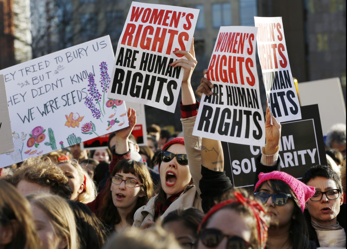 Women chant and hold signs during a rally and march on a A Day Without Women, part of International Womens Strike NYC, a coalition of dozens of grassroots groups and labor organizations, Wednesday, March 8, 2017, at Washington Square Park in New York. 