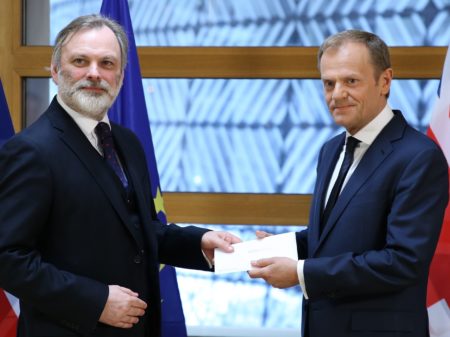 British Ambassador to the EU Tim Barrow, left, delivers Prime Minister Theresa May's formal notice of the U.K.'s intention to leave the bloc to European Council President Donald Tusk in Brussels Wednesday.