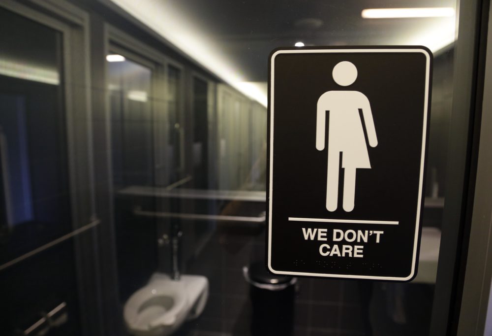 FILE- In this May 12, 2016 file photo, signage is seen outside a restroom at 21c Museum Hotel in Durham, N.C. (AP Photo/Gerry Broome, File)