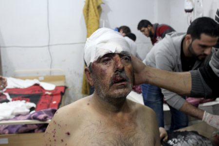 A wounded man receives treatment following airstrikes in Idlib province.