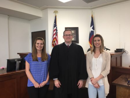 Program manager Kelli Wright, Judge Chad Bradshaw and supervision officer Meghan Ryan work at the Brazoria County Domestic Violence Court.