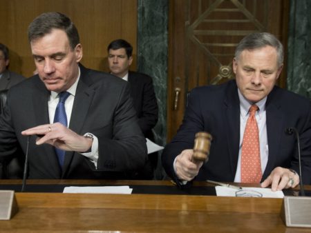 Sen. Richard Burr (right), Republican of North Carolina and chairman of the Senate Select Committee on Intelligence, arrives alongside Sen. Mark Warner, Democrat of Virginia and Committee vice chairman, for a hearing on Russian intelligence activities on March 30